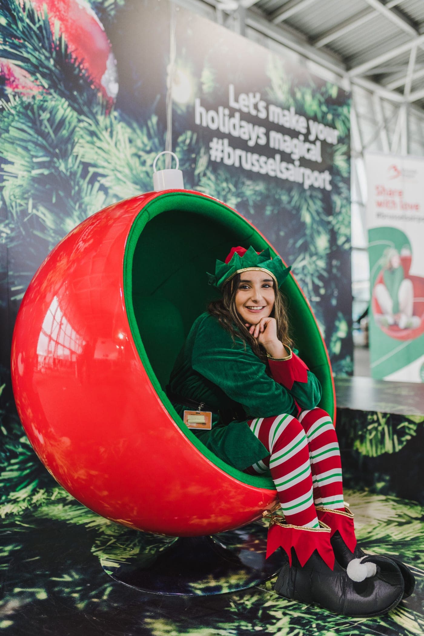 An elf in a red bauble seat, one of the instagrammable spots