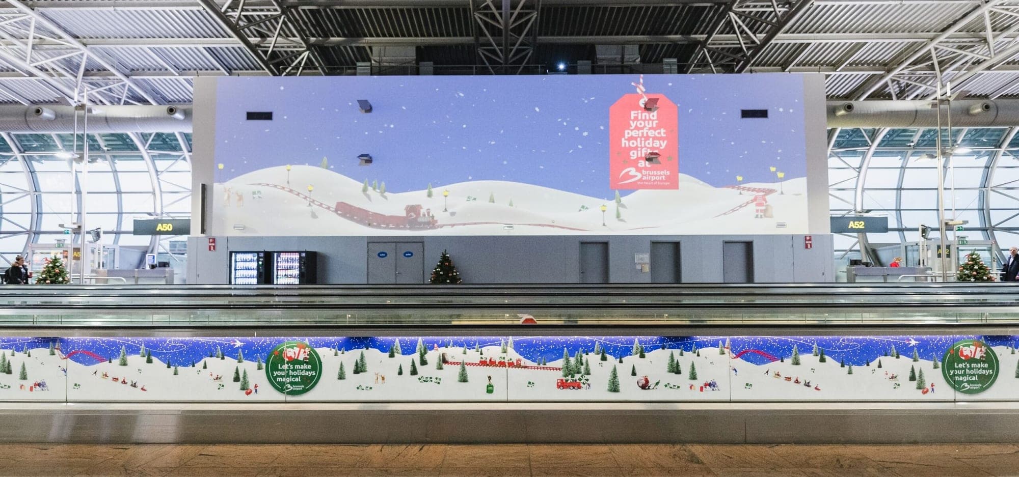 An immersive winter video wall above the airport walkway