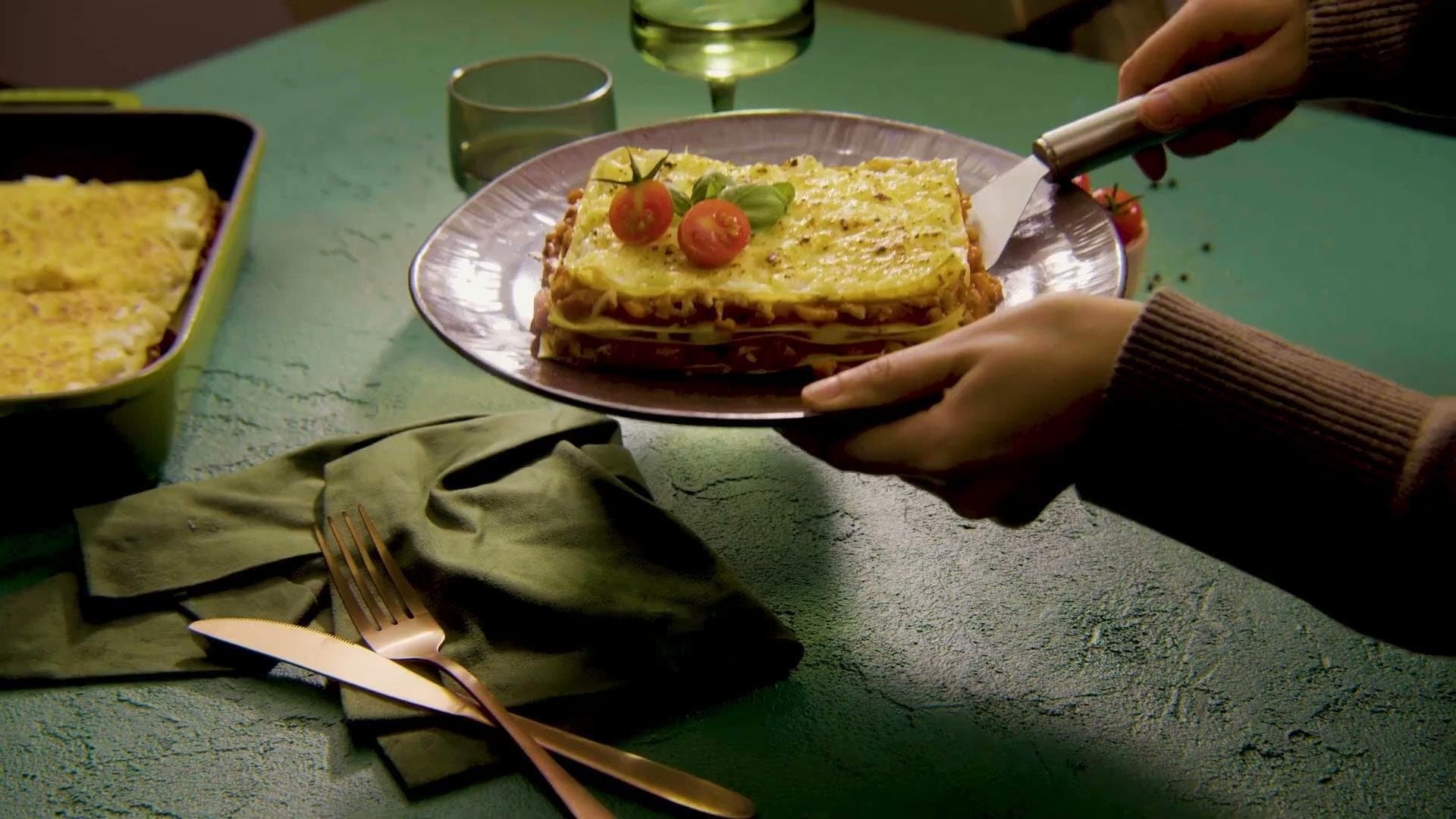 A Casa Cameo lasagna served on a green table