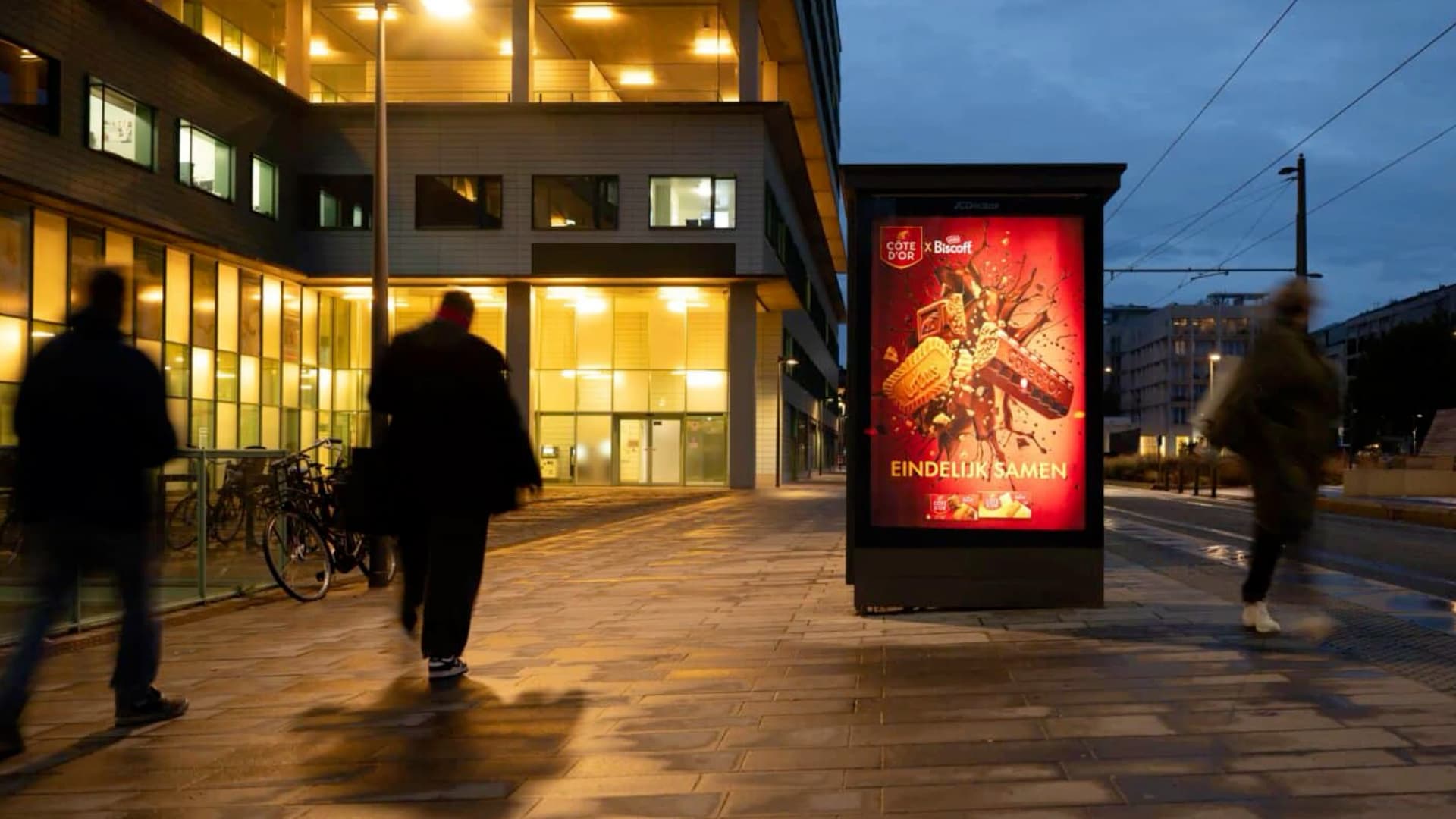Côte d’Or x Biscoff poster in a bus shelter at dusk
